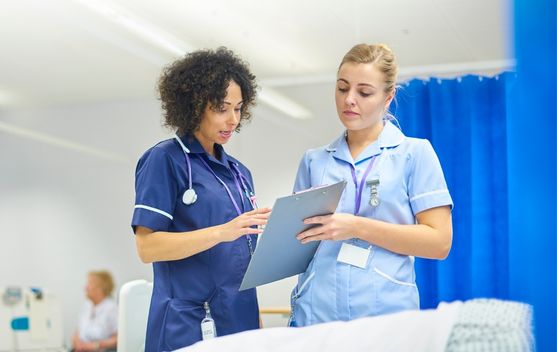 Aide-soignante qui aide et forme son apprentie